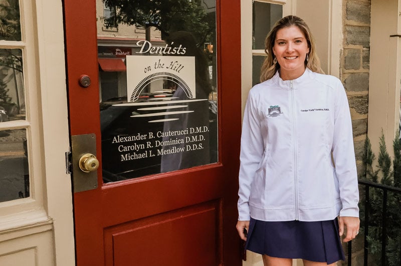 Dr. Carly in front of the dental office.